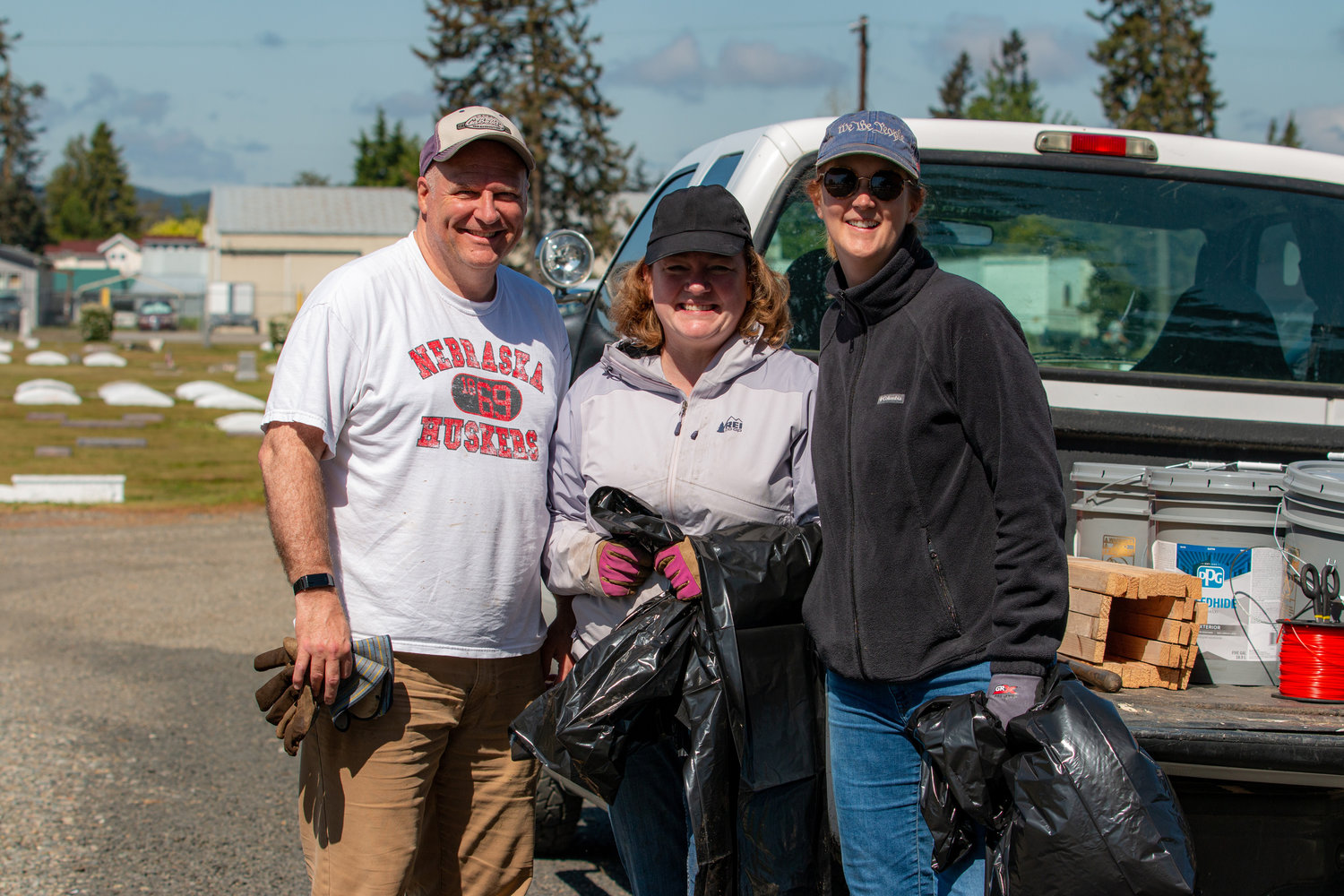 Centralia Community Development Director Emil Pierson, Anna Pierson and Centralia Mayor Kelly Smith Johnston pose for a photo at the work party to restore the Greenwood Memorial Park Saturday morning.